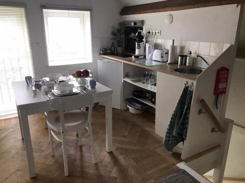 a small kitchen with a table and a counter top at B&B In de Oude Smederij Zaltbommel in Zaltbommel