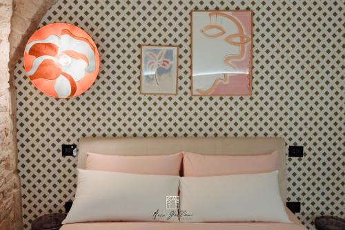 a bedroom with a bed and some pictures on the wall at Arco Galliani in Bitonto