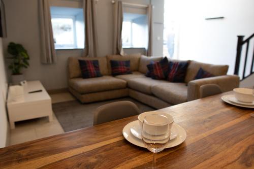 a living room with a table with a wine glass on it at Unique Barn conversion in Saddleworth in Oldham