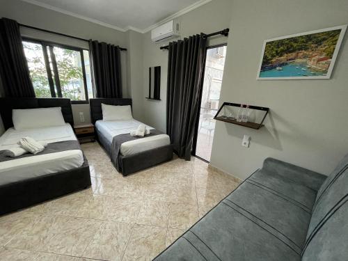 a living room with two beds and a couch at Villa Balbi 34 in Sarandë
