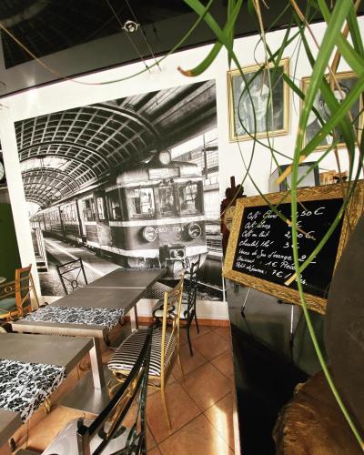 a restaurant with tables and a train on the wall at Interlaken in Nice