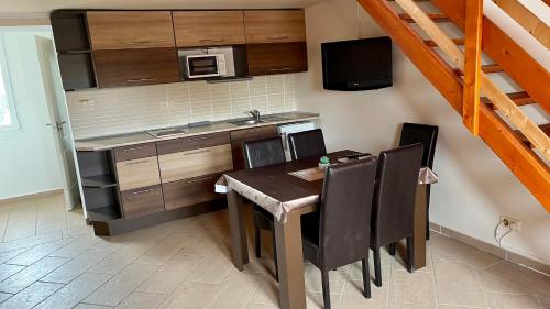 a small kitchen with a table and a microwave at Gyula Vár Panoráma Apartman in Gyula