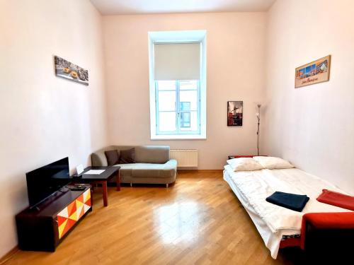 a living room with a bed and a couch at Oldtown Palasta Apartments in Riga