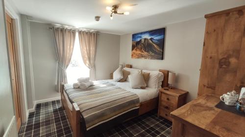 a bedroom with a bed and a window at The Boot Inn in Boot