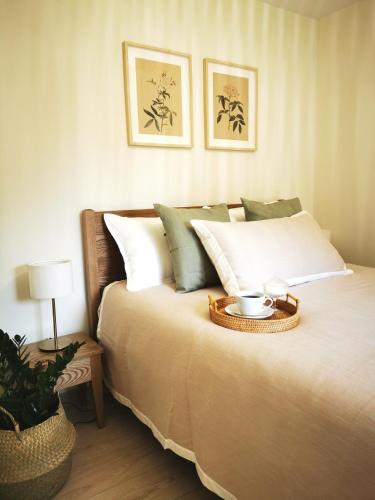 a bedroom with a bed with a tray on it at Pape holiday home in Pape