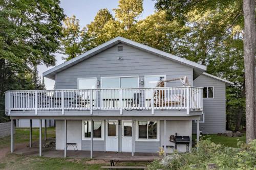 a house with a wrap around porch and a deck at High Lake Hideaway in Boulder Junction