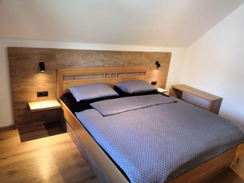 a bedroom with a bed with two pillows on it at Apartments Alp in Bohinj