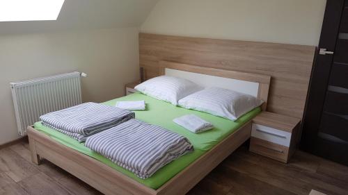 a bed with two pillows on top of it at Apartamenty Marynarki Wojennej, Dziwnów in Dziwnów