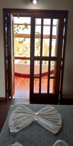 a room with a door with a bow on the floor at Hotel Ferrugem Eco Village in Garopaba