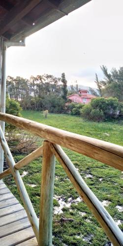 a porch railing with a view of a field at Hotel Ferrugem Eco Village in Garopaba