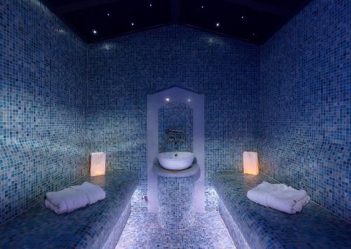 a bathroom with a sink and a toilet in a room at Astir Beach Hotel in Gouves