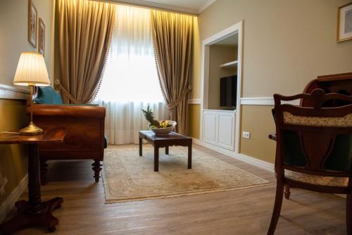 a living room with a piano and a window at Luna Hotel de Tábua in Tábua