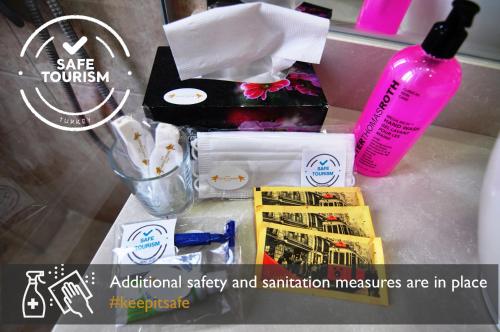 a counter top with a bottle of soap and other items at Angel's Home Suites - Angel Group Hotels in Istanbul