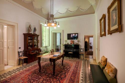 a living room with a table and a couch at Palazzo Rollo in Lecce
