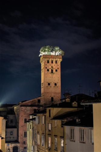 a tower with a tree on top of a building at Al Carmine Apartments Towers view with AC in Lucca