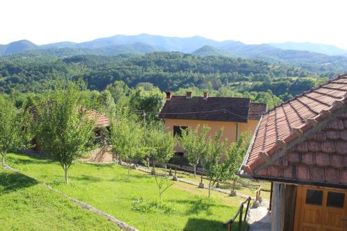 a view of a house with mountains in the background at Ethno Village Bogut in Bogutovac
