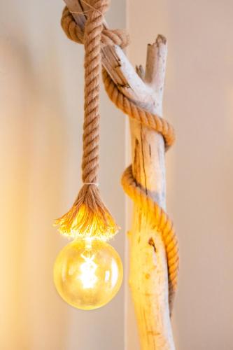 a light that is hanging from a rope at Gorgona Blue Apartments in Karpathos Town