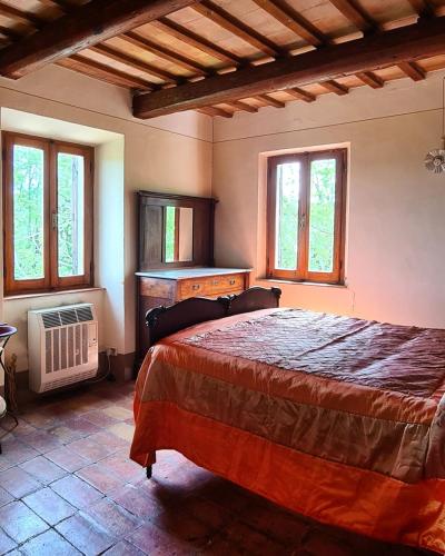 Ένα ή περισσότερα κρεβάτια σε δωμάτιο στο La Cascina di Muttley