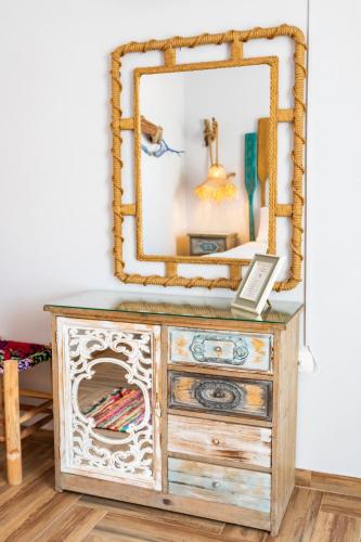 a mirror on top of a dresser in a room at Gorgona Blue Apartments in Karpathos Town