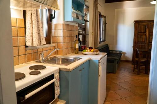 a small kitchen with a sink and a stove at Arhondiko in Sougia