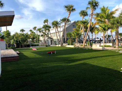 a park with palm trees in front of a building at The Perry Hotel & Marina Key West in Key West