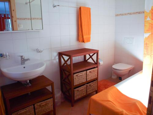 a bathroom with a sink and a toilet at B&B Casa Moni in Bosco Gurin