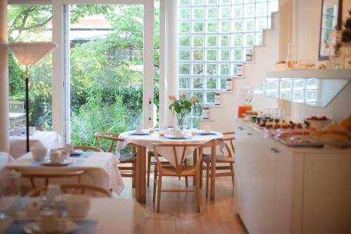 a kitchen with a table and chairs and a window at Hotel Van Bunnen in Knokke-Heist