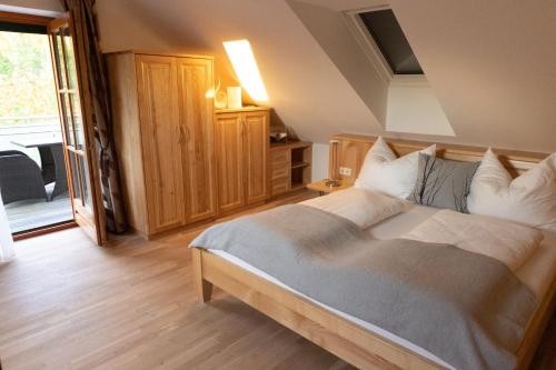 a bedroom with a large bed with white pillows at Weinberghaus am Burgstallkogel in Leibnitz