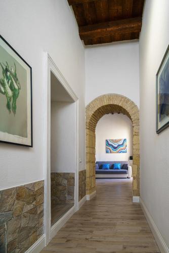a hallway with an archway with a bed in a room at The Good Place in Cagliari