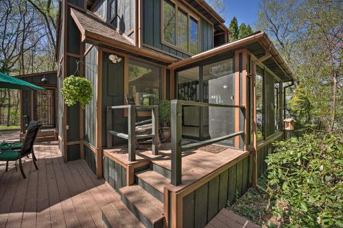 a wooden house with glass doors and a deck at Sawyer Retreat with Fire Pit Less Than 2 Mi to Beaches! in Sawyer