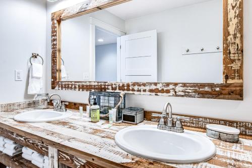 a bathroom with two sinks and a large mirror at Summer Breeze in Sayner