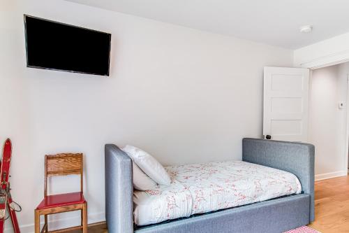 a living room with a couch and a flat screen tv at Summer Breeze in Sayner