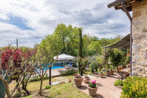 a garden with a swimming pool and some plants at Casa vacanze San Giusto in Sovicille