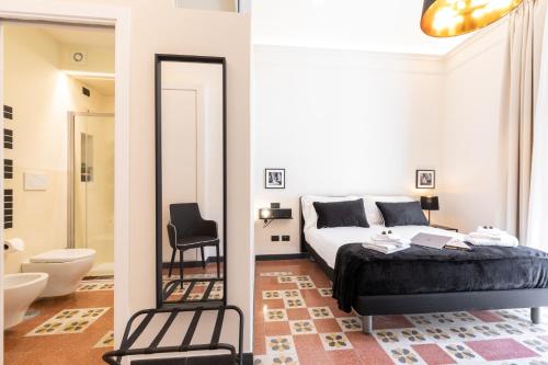a bedroom with a bed and a mirror at Foresteria di Piazza Cavour - Luxury Suites & Guest House in Rome