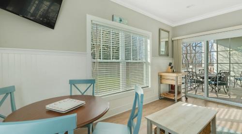 a dining room with a table and chairs and a window at The Cliffside Resort Condominiums in Greenport