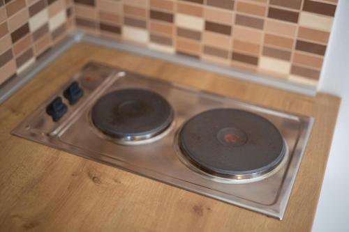 a stove top with two burners sitting on a wooden floor at Malinska -Krk in Malinska
