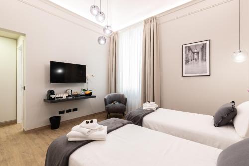 TV tai viihdekeskus majoituspaikassa Foresteria di Piazza Cavour - Luxury Suites & Guest House