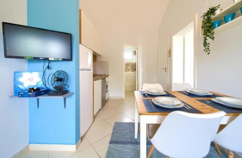 a kitchen and dining room with a table and chairs at Malinska -Krk in Malinska