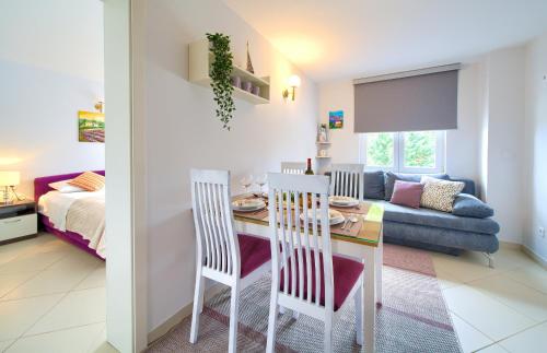 a dining room and living room with a table and chairs at Malinska -Krk in Malinska