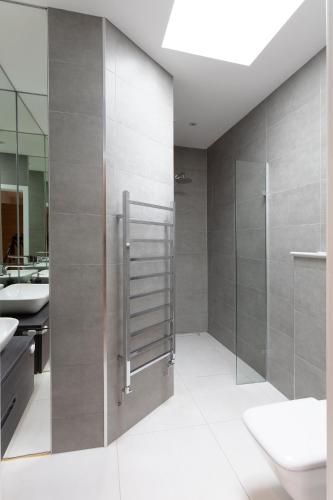 a bathroom with a shower and a sink at Immaculate Central Windsor Town House with parking in Windsor
