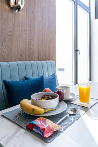 a breakfast table with a bowl of cereal and a banana at Zurin Charm Hotel in Lisbon