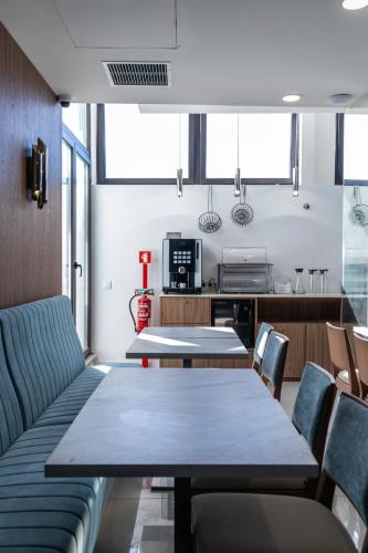 a dining room with a table and chairs at Zurin Charm Hotel in Lisbon