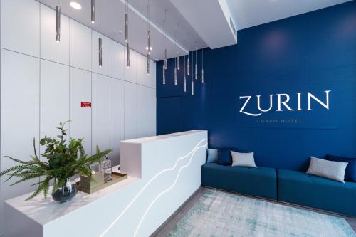 a lobby with a blue wall and a blue couch at Zurin Charm Hotel in Lisbon