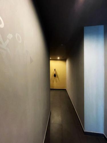 a dark hallway with a white wall and a door at Hotel Royal Paestum in Paestum