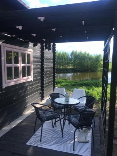 a patio with a table and chairs on a deck at 83 Bredynki in Biskupiec