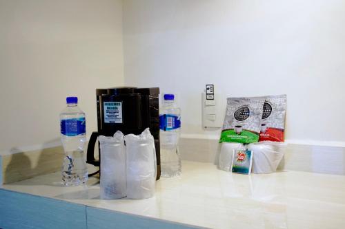 a counter with bottles of water and bags on it at Best Western Real Tula Express in Tula de Allende