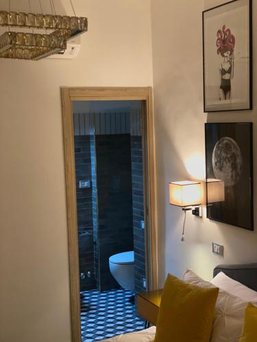 a bedroom with a door to a bathroom with a toilet at Santafe' in Vietri