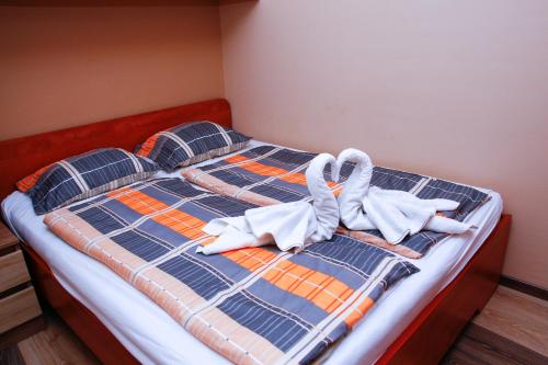 a bedroom with a bed with towels on it at Club 218 Wellness Luxus Apartman in Siófok
