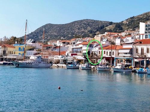 a group of boats docked in a harbor with houses at Aegean Blu Port House Pythagoreio in Pythagoreio