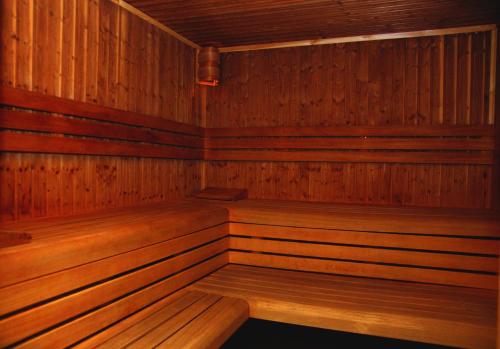 a wooden sauna with wooden benches in it at Club 218 Wellness Luxus Apartman in Siófok